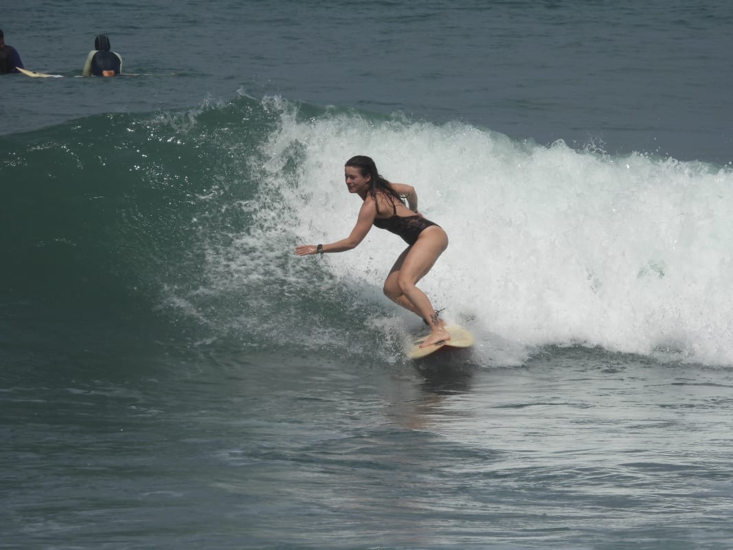 Fun group surfing lesson atmosphere with coach at Cimaja Beach